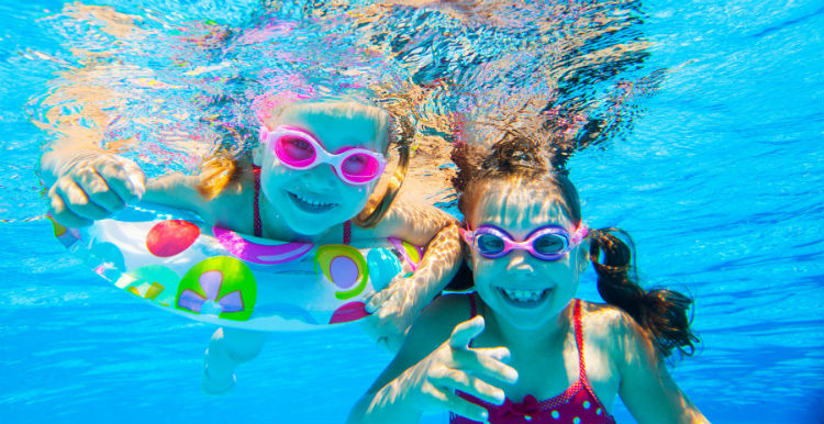 Kids swimming safely in the pool