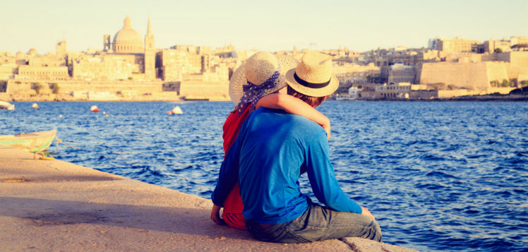 Happy couple admiring Malta harbour