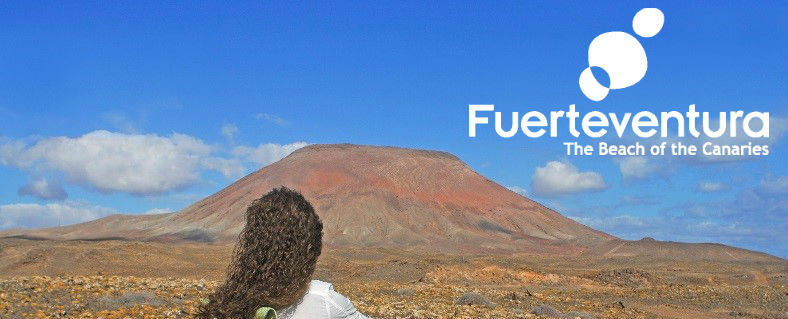 A mountain in Fuerteventura with the tourist board destination in the corner.