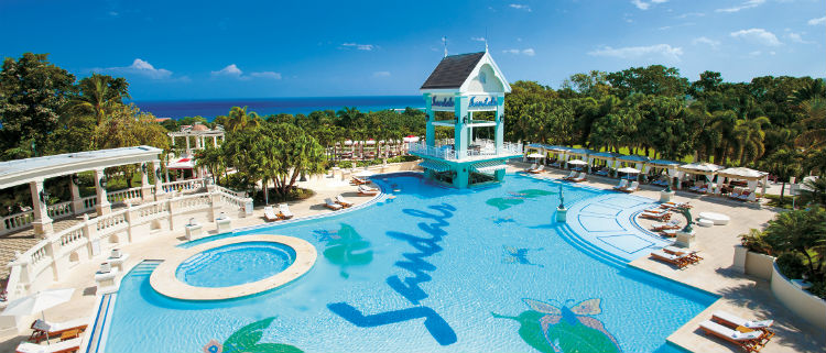 The pool area of Sandals Resorts in the Carribean. You can see the Sandals logo at the bottom of the pool.