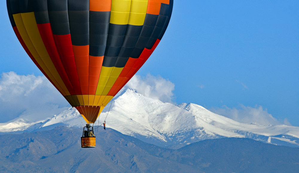 Hot air balloon with Colorado's Rocky Mountains in the background.jpeg