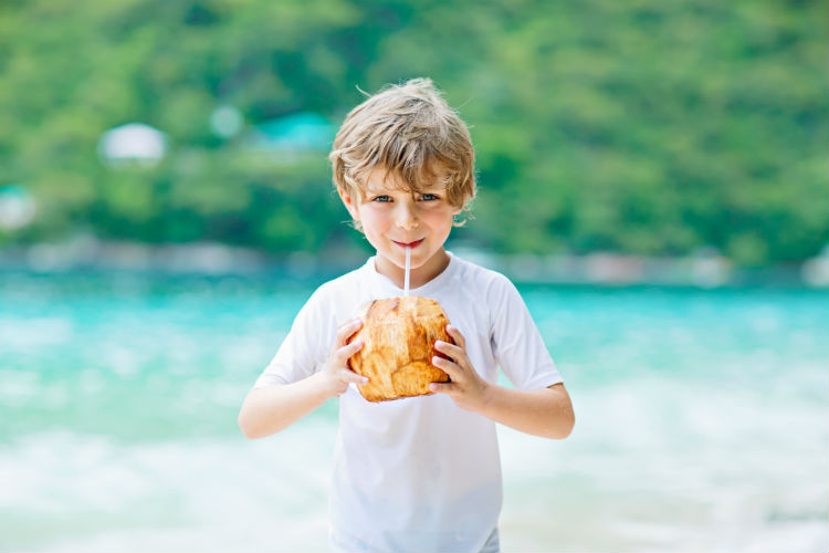 A boy drinking coconut juice in Jamaica