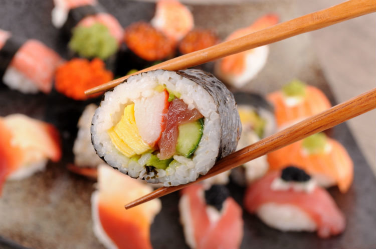 Futomaki sushi held by chopsticks.jpg