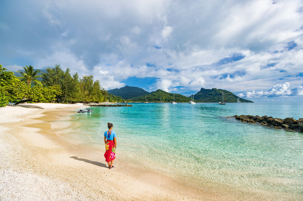 A lone woman on a beach in French Polynesia
