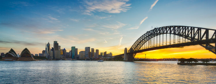 Sydney Harbour Bridge with a yellow and blue sunset.