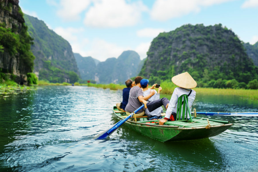 Tourists on a guided river boat tour in Vietnam