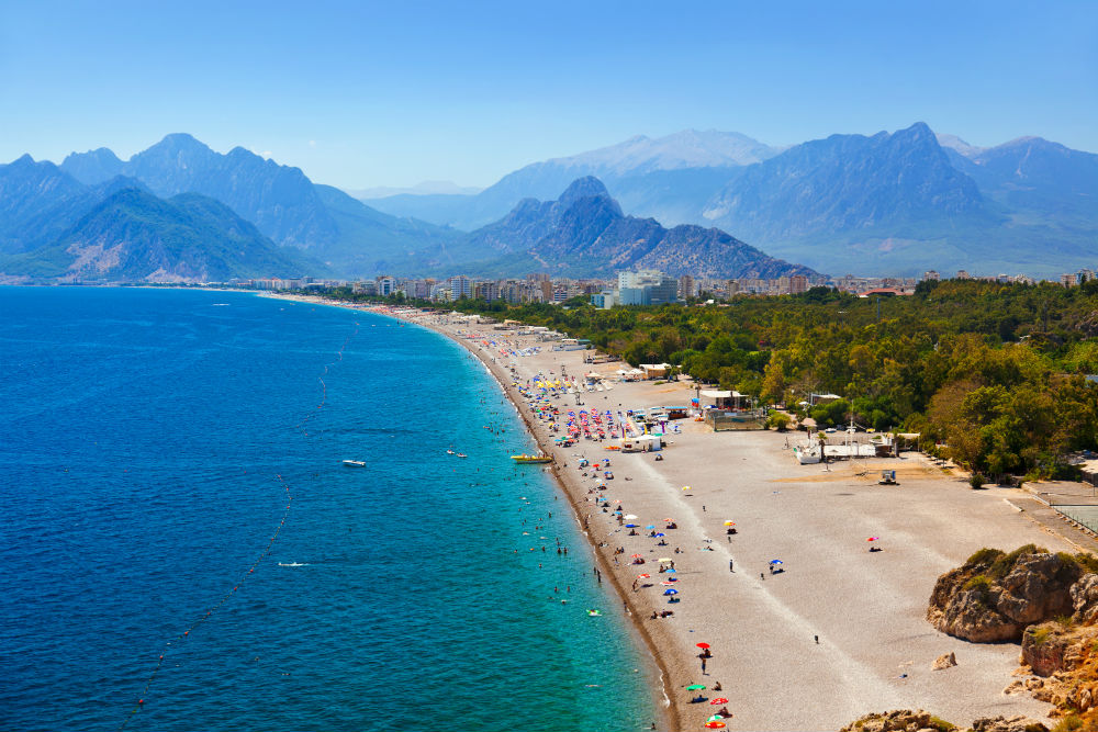 A beach in Turkey with the mountains in the background. Taken from a high angle. 