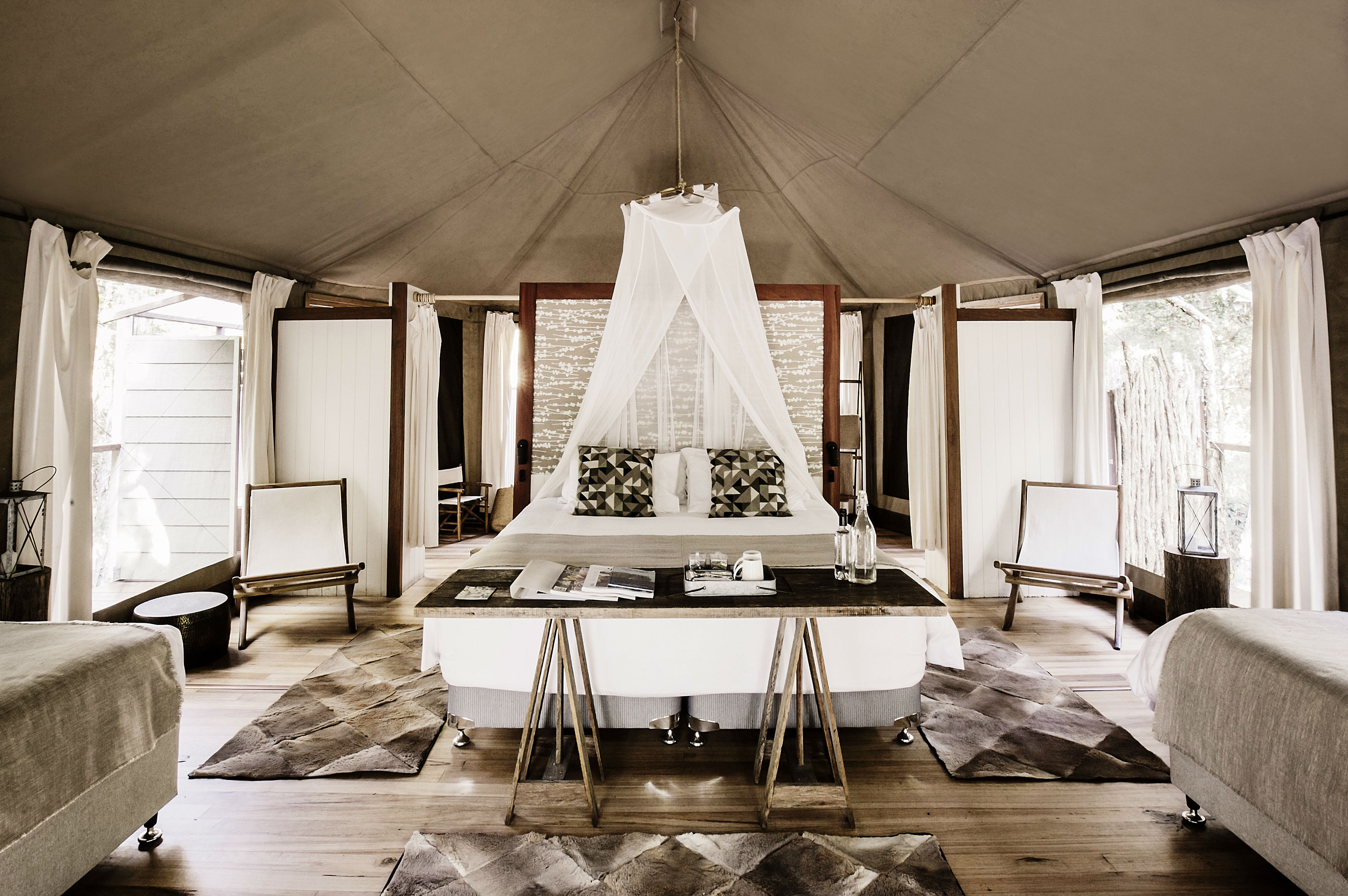 A luxury glamping text with white and light brown textiles.