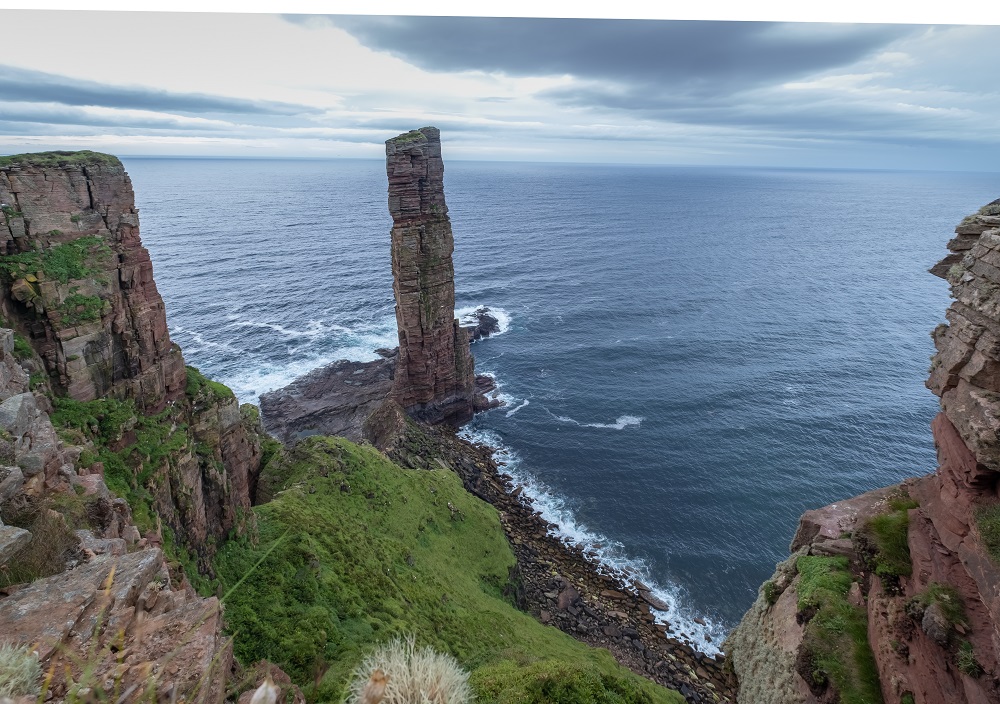 A picture of the Scottish highlands from the top of a cliff overlooking water