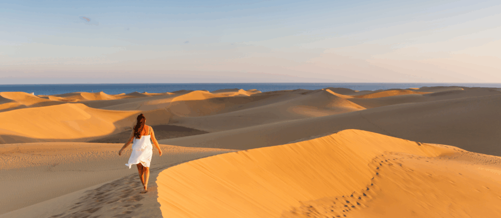 Person walking on the sand at maspalomas dunes bech. Gran Canaria, Spain